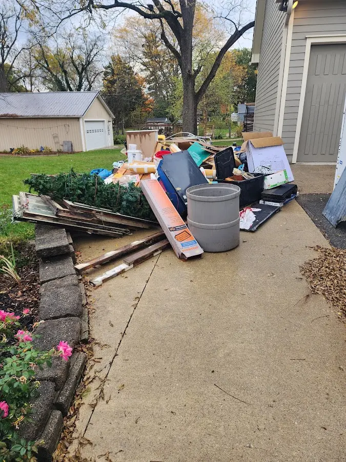 Dumpster being loaded with debris for Roofing Dumpster Rental in Wellsville